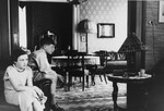 Two German Jewsh children sit in the living room of their apartment.