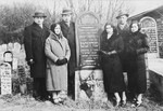 A Polish-Jewish family poses by the grave of its father, Moshe Itzchak Frucht.