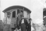 A Romani family poses at the entrance to their caravan.