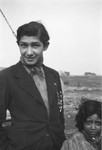 A Romani youth and a child pose for a photograph.