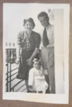 Photo album page showing Daisy Breuer in arms of her mother (Lilly Breuer) and father (Dr.
