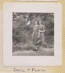 Sisters Sonia and Fania nee Szwarcman pose outside in a garden.