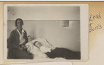Leah Szwarcman nurses her son Boris who is lying in bed.