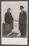 Joseph and Fania Pinczuk pose by the grave of their infant son Aaron Jonah in the Linz displaced persons camp.