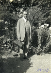Dr. Josef Kohn stands outside holding his doctor's bag.