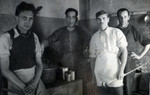 Four men pose in the kitchen at Ferramonti.

Ernest Hellinger is pictured second from the right.