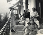 Female patients rest on the terrace of a sanatorium in Merano, Italy