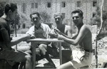A group of men sitting outside playing cards at an unidentied location (possibly Rhodes).