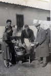 Ernest Hellinger serves soup to other internees in the Ferramonti internment camp.