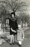 Anna Kohn poses on a tree lined path an with unidentified toddler.