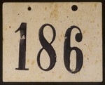 Numbered identification tag worn by Henry Schmelzer when he was a member of a Kindertransport sent from Austria to England in December 1938.