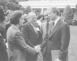 Vladka Meed shakes the hand of President Jimmy Carter at a White House Rose Garden ceremony marking the official presentation of the report of the U.S.