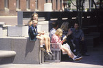 Visitors sit on benches in Thorn Alley, near the 15th Street entrance to the U.S.