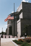 View of the 14th Street entrance to the U.S. Holocaust Memorial Museum, in which the American flag is flying at half mast to commemorate the first anniversary of the September 11, 2001 terrorist attacks.