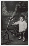 Victor Nahmias poses next to a bicycle.